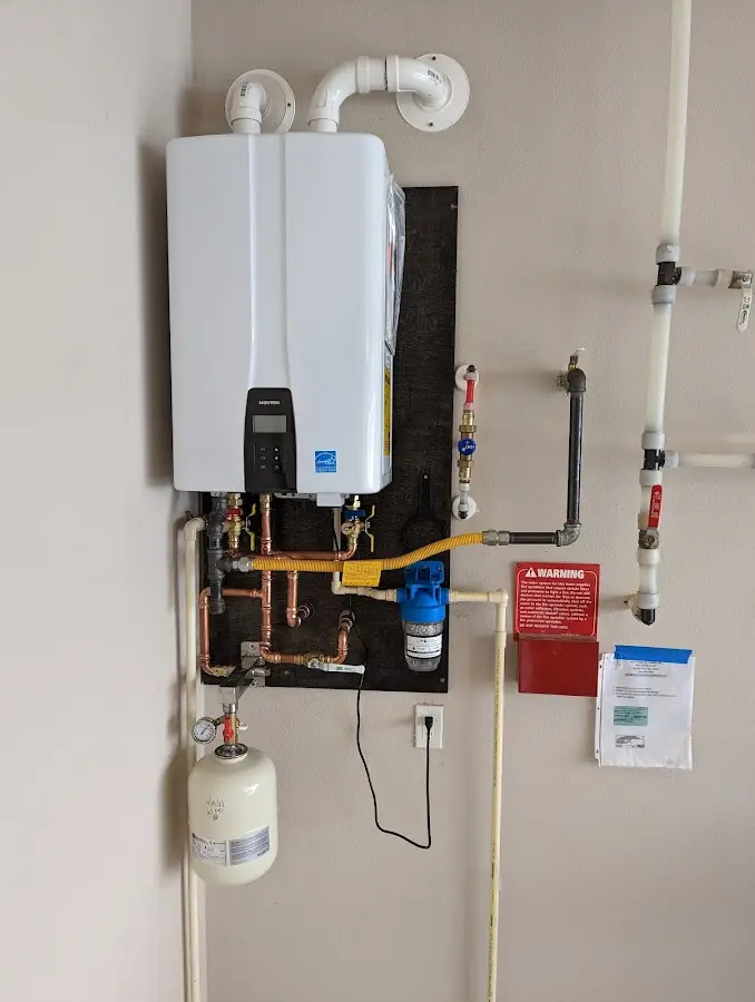 Professional plumber installing copper piping in a Lake Worth home